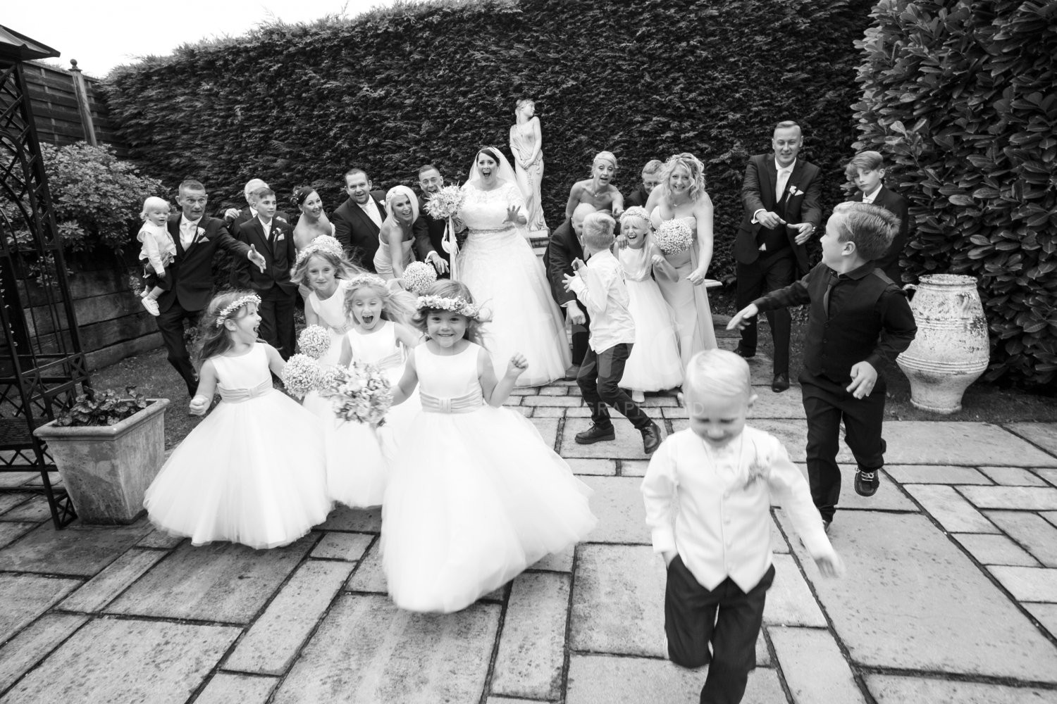 Its just as exciting as Christmas Bridal Party, Flower girl, paige boy, running, wedding photography, Yew Lodge Garden, captcha, black and white photography, reportage